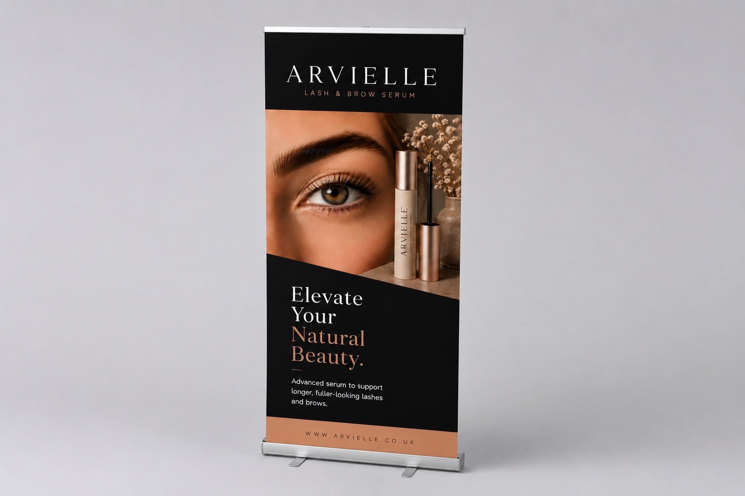 Luxury lash serum roll-up banner stand in a minimalist studio setting